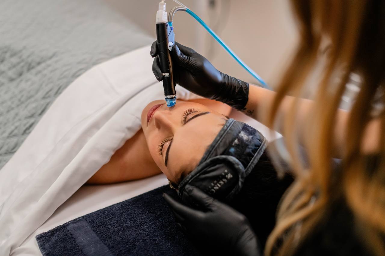 A SkinLab provider performing a facial treatment